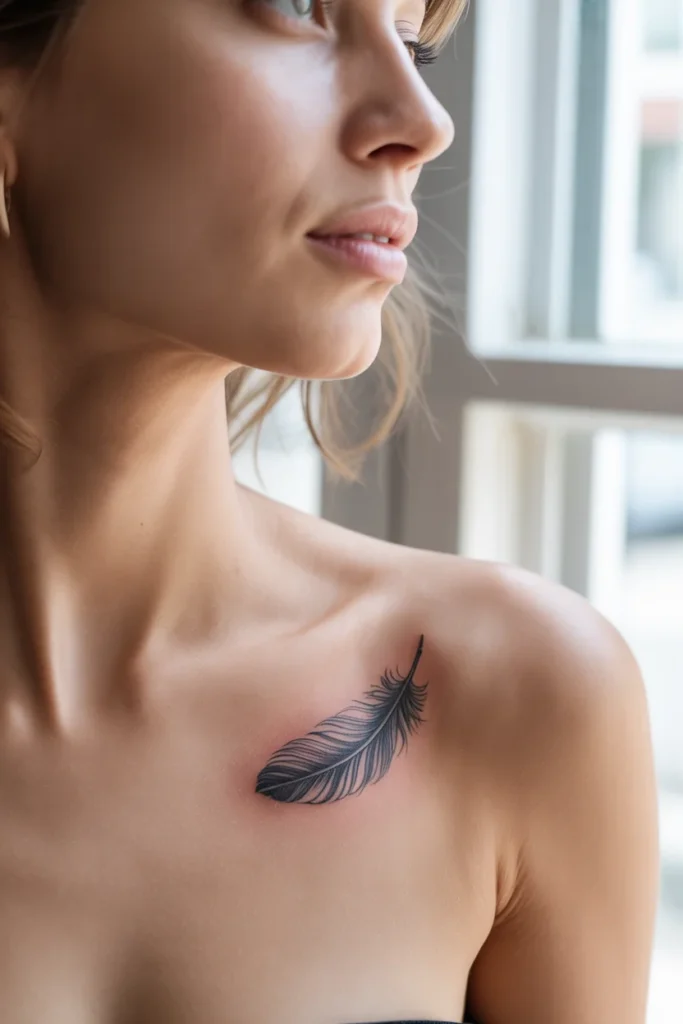 Small feather collarbone tattoo