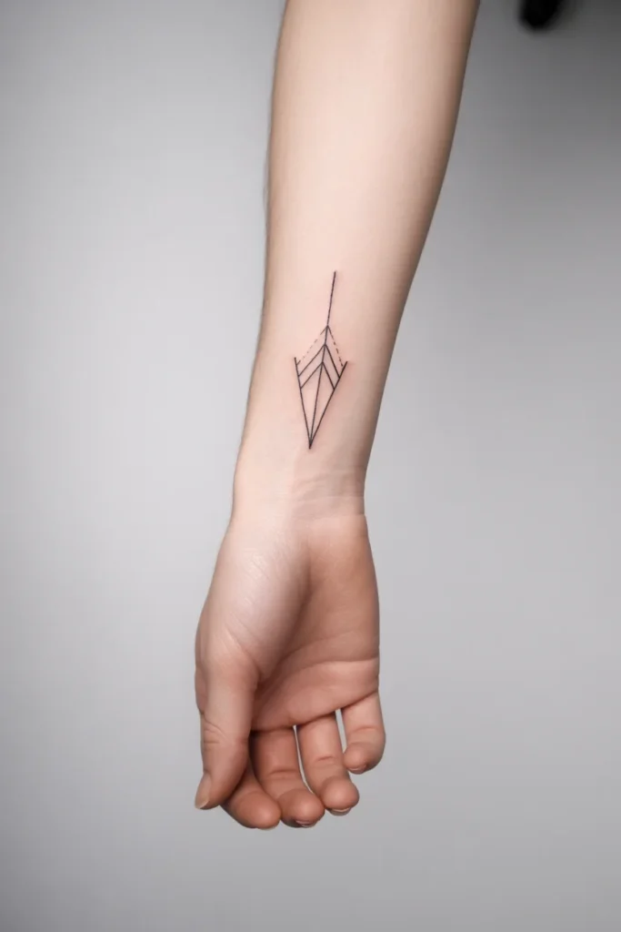 Tiny arrow forearm tattoo