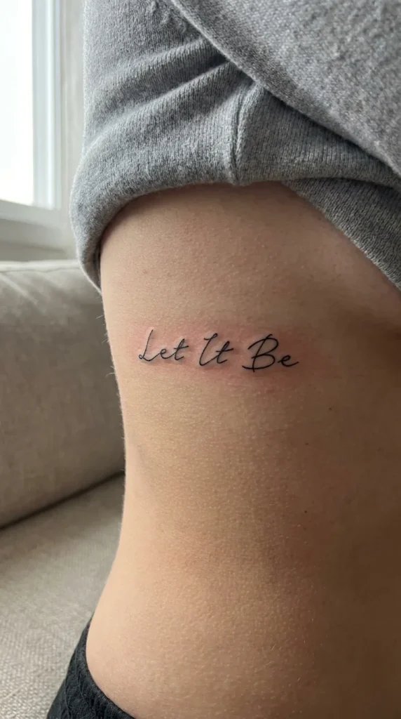 Fine line word tattoo ribs minimalist